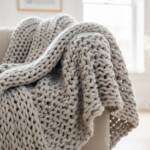 Soft gray chunky knit throw blanket on sofa