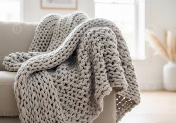 Soft gray chunky knit throw blanket on sofa