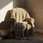 Sunlit armchair with chunky knit blanket and book - hygge lifestyle